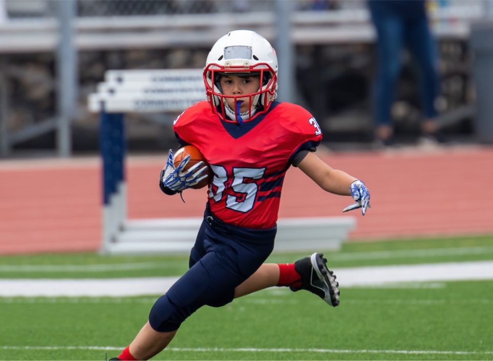 Young boy playing football