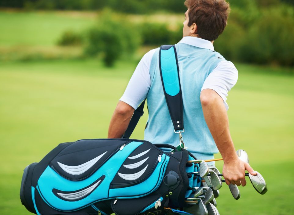 Man carrying a golf bag