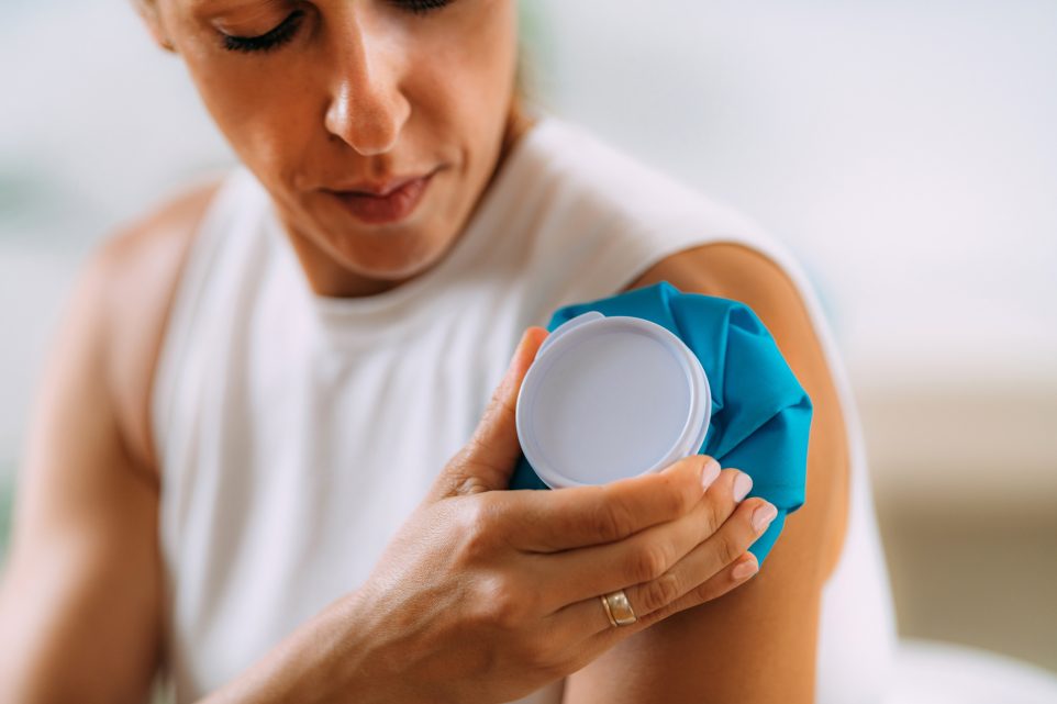 Frozen Shoulder. Woman Holding Cold Compress, Ice Bag Pack On Her Painful Shoulder